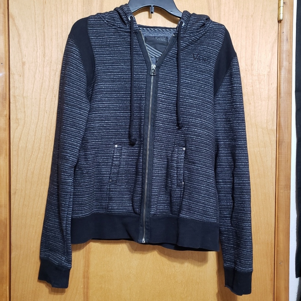 Boys zip up Van's hoodie.